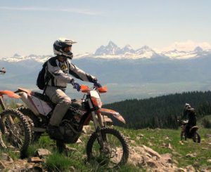 rider on motorcycle, mountains in background